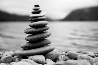 Zen Balancing Pebbles Next to a Misty Lake – Free Download