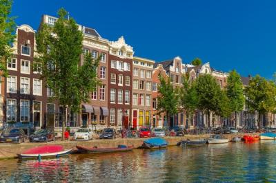 Stunning City View of Amsterdam Canals, Houses, Boats, and Bicycles – Free Download