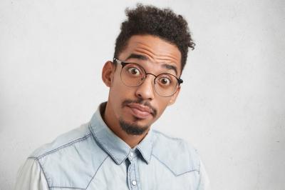 Portrait of Young Afro American Man with Trendy Hairdo and Puzzled Expression – Free Download