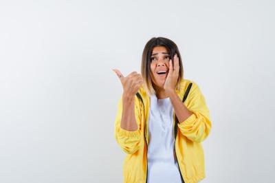 Excited Woman in T-Shirt and Jacket Giving a Thumbs Up â Free Download