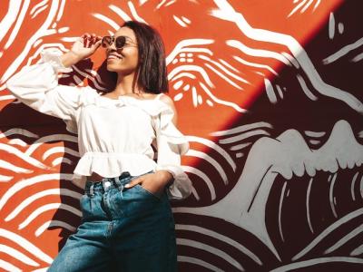 Portrait of a Young Beautiful Black Woman Smiling in White Jeans – Free Stock Photo for Download