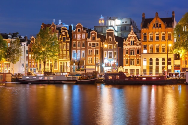 Canal Views of Amsterdam: Typical Dutch Houses and Houseboats Reflected at Night – Free Download