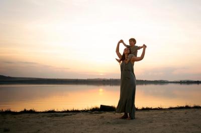 Joyful Moments of a Mother and Child at the Beach – Free Download