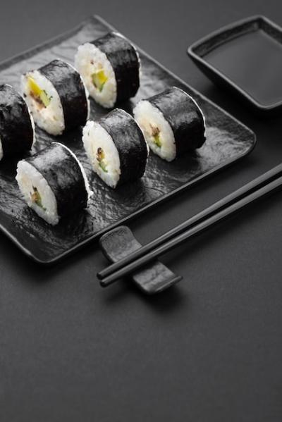 High Angle View of Sushi Rolls with Chopsticks and Sauce – Free Download