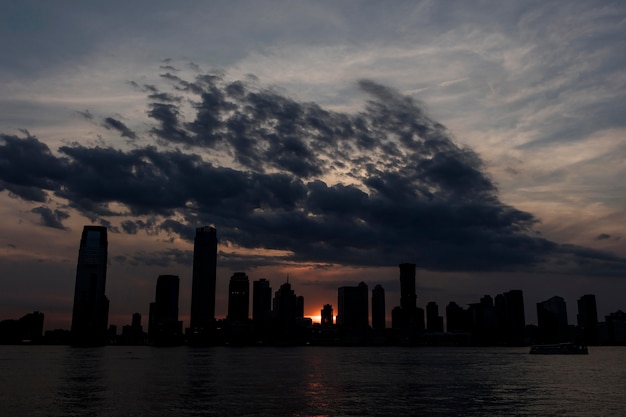 Stunning Cityscape Featuring Majestic Buildings Reflected in Water – Free Download