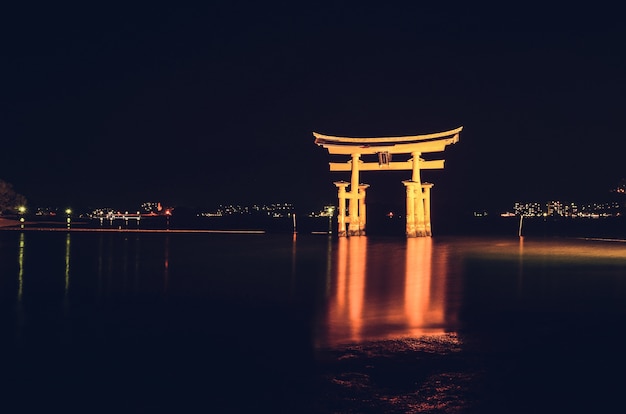 Illuminated Itsukushima Floating Torii Gate at Night in Miyajimacho, Japan – Free Download