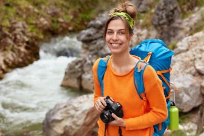 Young Traveler Enjoying Nature with Camera and Backpack – Free Stock Photo