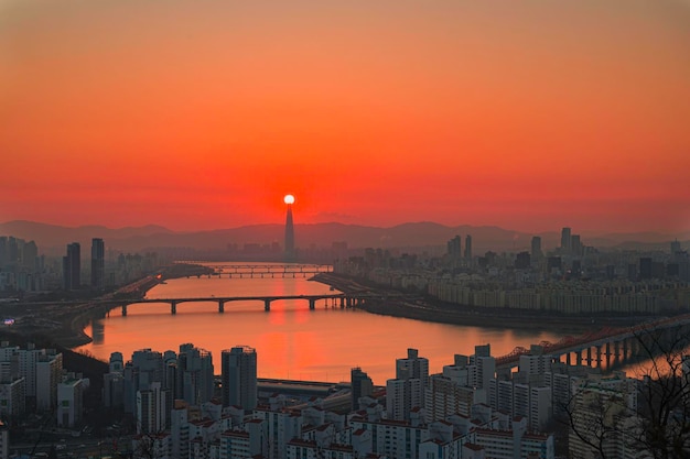 Stunning Sunset View of a Bridge over River and City Skyline – Free Download