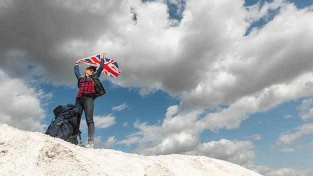 Woman Raising Flag Outdoors – Free Download