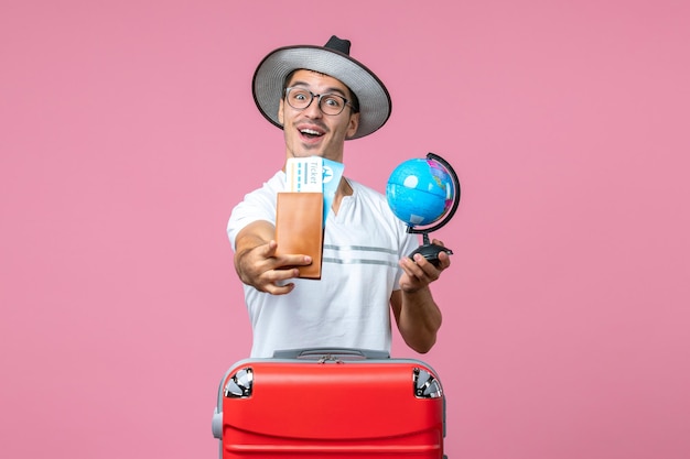 Young Man Holding Tickets and Globe on Pink Wall – Free Stock Photo, Download Free