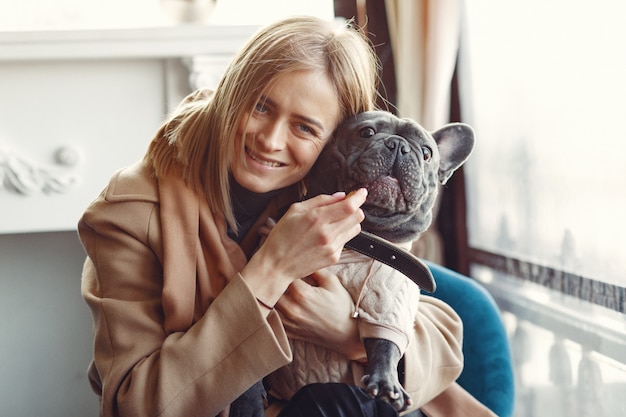 Elegant Woman in a Brown Coat with Black Bulldog – Free Download