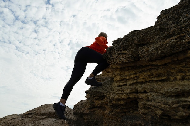 Athletic Young Woman Climbing Rocks Outdoors – Free Download