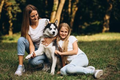 Two Sisters Enjoying Time with Their Dog in the Park – Free Download