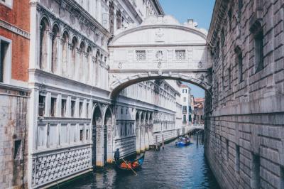 Person Rowing a Gondola Under The Bridge of Sighs in Venice, Italy – Free to Download