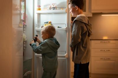 Medium Shot of Kids Looking in the Fridge – Free Download