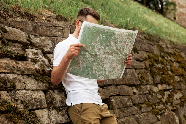 Low Angle Shot of Young Man Reading Map – Free to Download