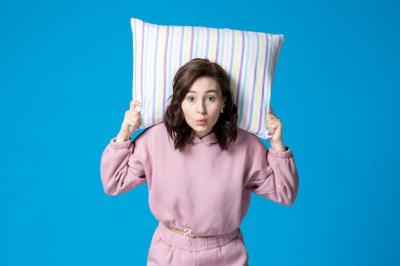 Young Female in Pink Pajamas Holding Pillow – Free Download Stock Photo