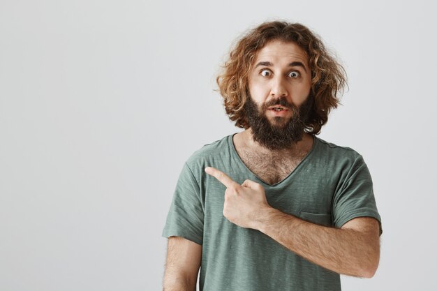 Concerned Middle-Eastern Man Pointing Left – Free Stock Photo for Download