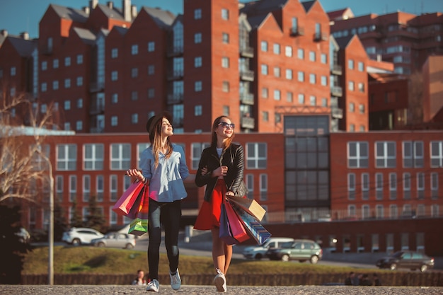 Two Girls Shopping on Sunny City Streets – Free to Download