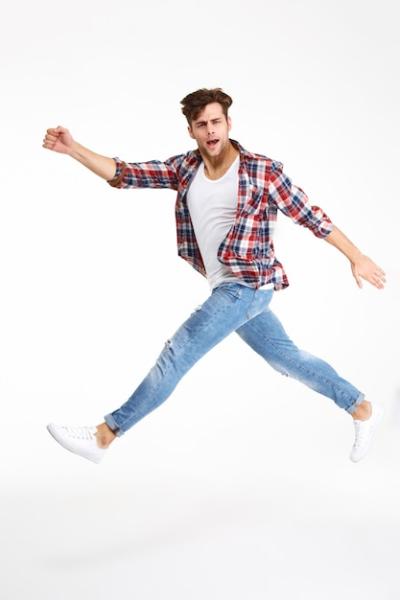 Full Length Portrait of a Casual Young Man Jumping – Free Download