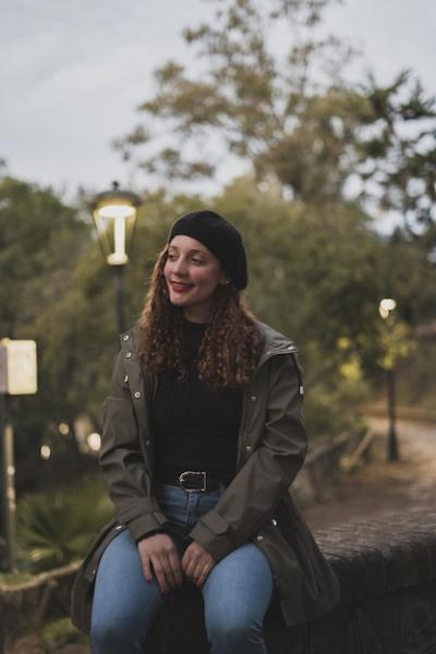 Female in Khaki Jacket and Black Warm Hat Sitting in the Park – Free Stock Photo for Download