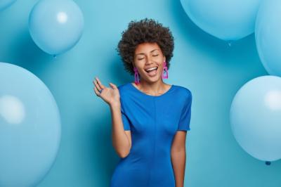 Overjoyed Afro American Woman in Elegant Blue Dress Surrounded by Festive Balloons – Free Stock Photo Download