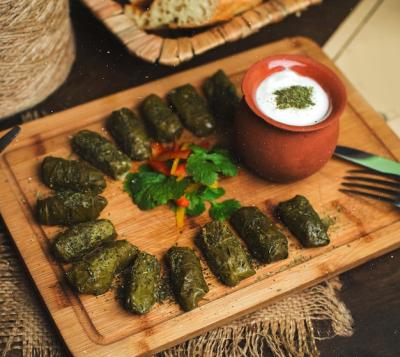 Top View of Green Dolma with Yogurt on a Brown Desk – Free Download