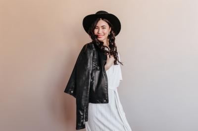 Adorable Asian Woman in Leather Jacket – Studio Shot of Laughing Korean Woman on Beige Background | Free Download