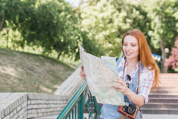 Young Woman with Camera and Map – Free Stock Photo for Download