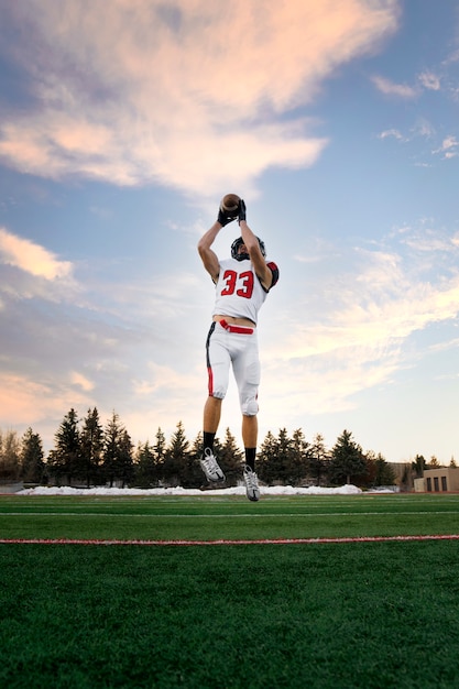 American Male Football Player in Uniform on the Field – Free Download