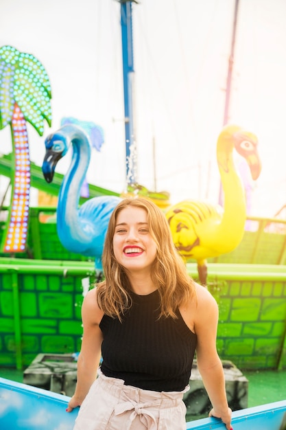 Smiling Young Woman at Amusement Park Fountain – Free Download