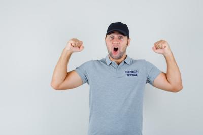 Young Technician Celebrating Success – Free Stock Photo for Download