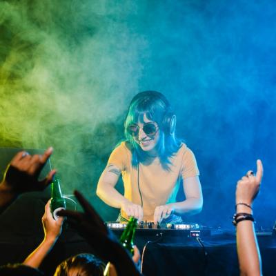 Happy Female DJ Entertaining a Large Crowd – Free to Download