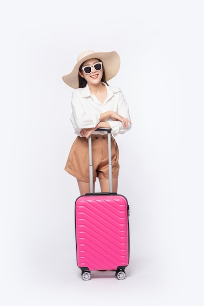 Woman Traveling with Hat, Glasses, and Suitcases – Free Stock Photo Download