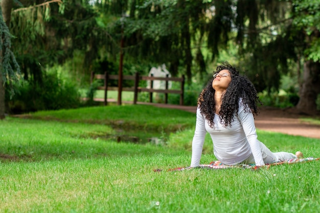 Young Woman Practicing Yoga in a Serene Park | Free Stock Photo Download