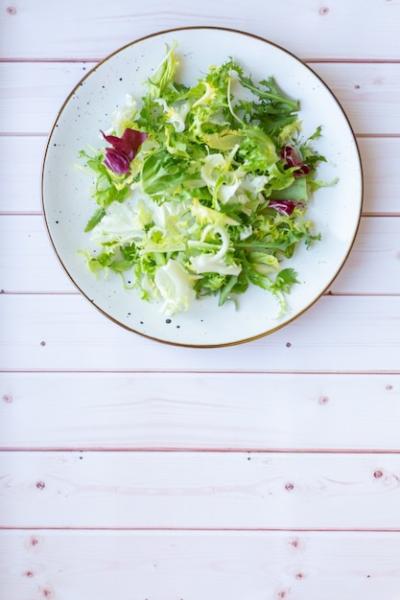 Fresh Salad on White Ceramic Plate on Wooden Surface – Free Stock Photo for Download