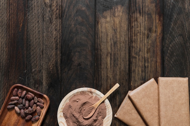 Cocoa Powder and Beans with Wrapped Chocolate Bar on Wooden Table – Free Stock Photo, Download for Free