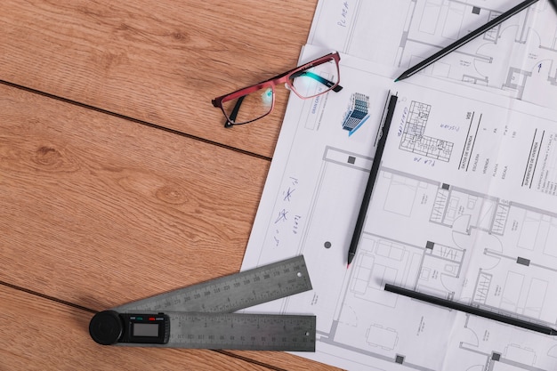 Ruler and Glasses Next to Blueprint – Free Download