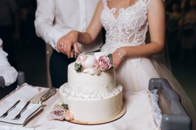 Bride and Groom Cutting a Beautifully Decorated Wedding Cake – Free Download