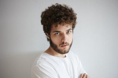 Negative Human Facial Expressions and Emotions: Gloomy Young European Male Headshot – Free Download