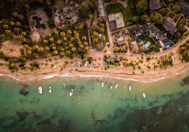 Overhead View of Charming Houses and Small Boats by the Seashore – Free Download