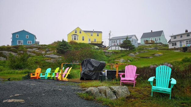 Empty Colored Chairs Against City Buildings in Peggy’s Cove â Free Stock Photo for Download