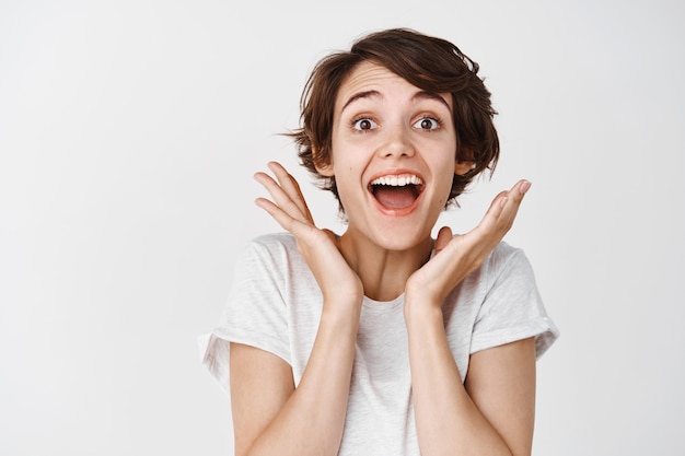 Surprised and Happy Woman Gasping in Awe Against a White Wall – Free Download