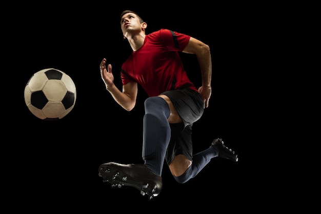 Dynamic Action Shot of a Young Caucasian Football Player Isolated on Black Background – Free Download