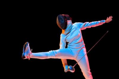 Teen Girl Practicing Fencing with Sword in Neon Light – Free Download