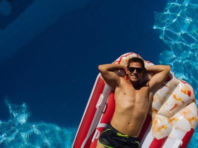 Man Relaxing on Beach Mat in Villa Pool – Free Download