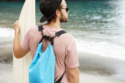 Beginner Surfer Awaiting Instructor by the Blue Ocean – Free to Download