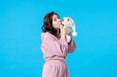 Young Female in Pink Pajamas with Toy Bear on Blue – Free Stock Photo for Download