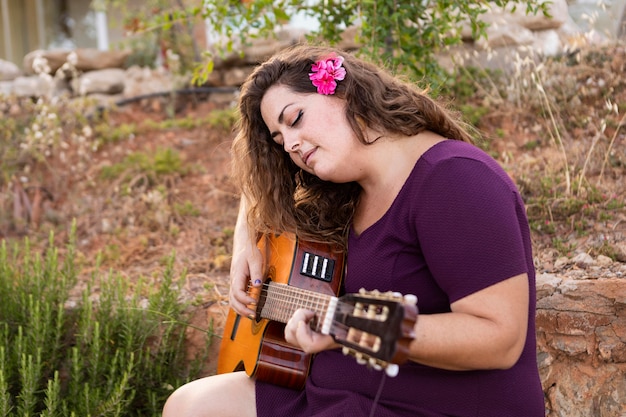 Woman Playing Guitar with Flower in Hair – Free Stock Photo, Download Free