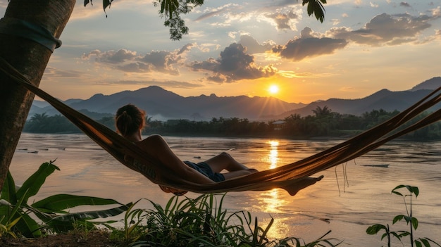 A Backpacker Relaxing on a Hammock with a Sunset View Over the Mekong River in Laos – Free Download